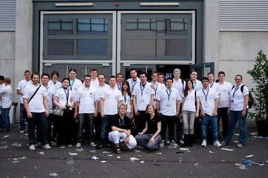 The Manaflask crew outside a hall at Gamescom, about twenty-five people in matching white shirts